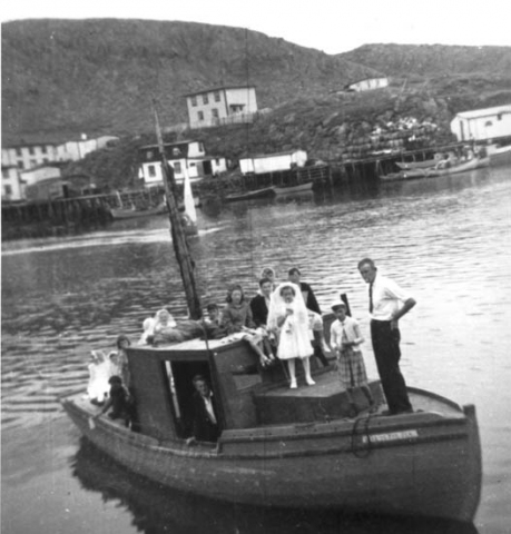 090: Barrys' longliner. Thomas Barry in the wheelhouse, Mary Barry on the hatch (in white),  William Barry on the bow. Viola Carroll is also in the picture. Frank Ryan's house  top center; Leo Whelan's house lower center; Mike Carroll's house upper right; Denis  McCarthy's and J V McCarthy's houses upper left; Mike Reddy's house lower left.  (circa 1961) [courtesy of Mary (Barry) Bruce]  - Thomas, Mary and William children of Thomas Barry &amp;amp; Anne Dollimont; Viola daughter of  Patrick Carroll &amp;amp; Nell Mulrooney
